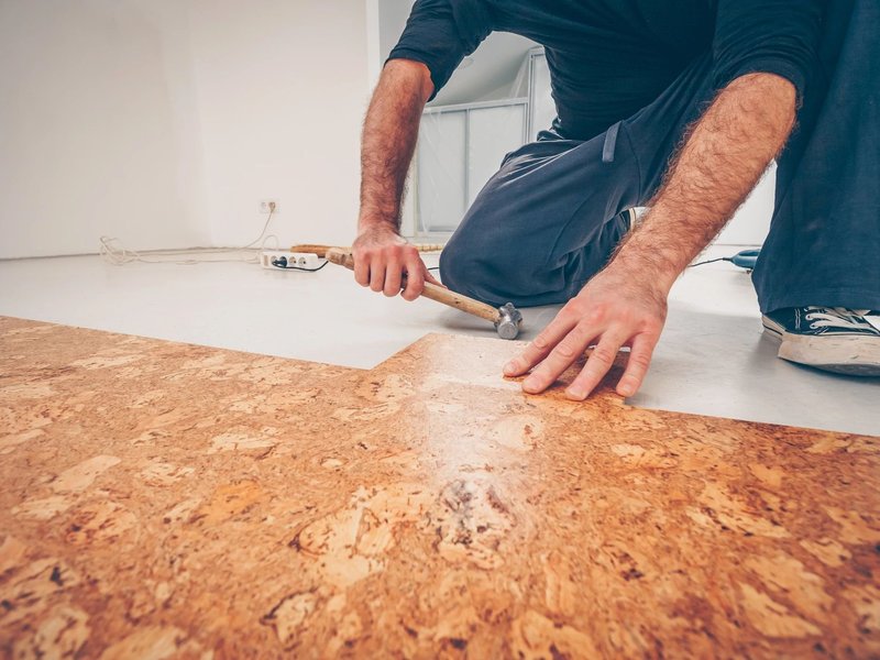 Person installing cork flooring from Carpet & Flooring By Denny Lee in Abingdon, MD